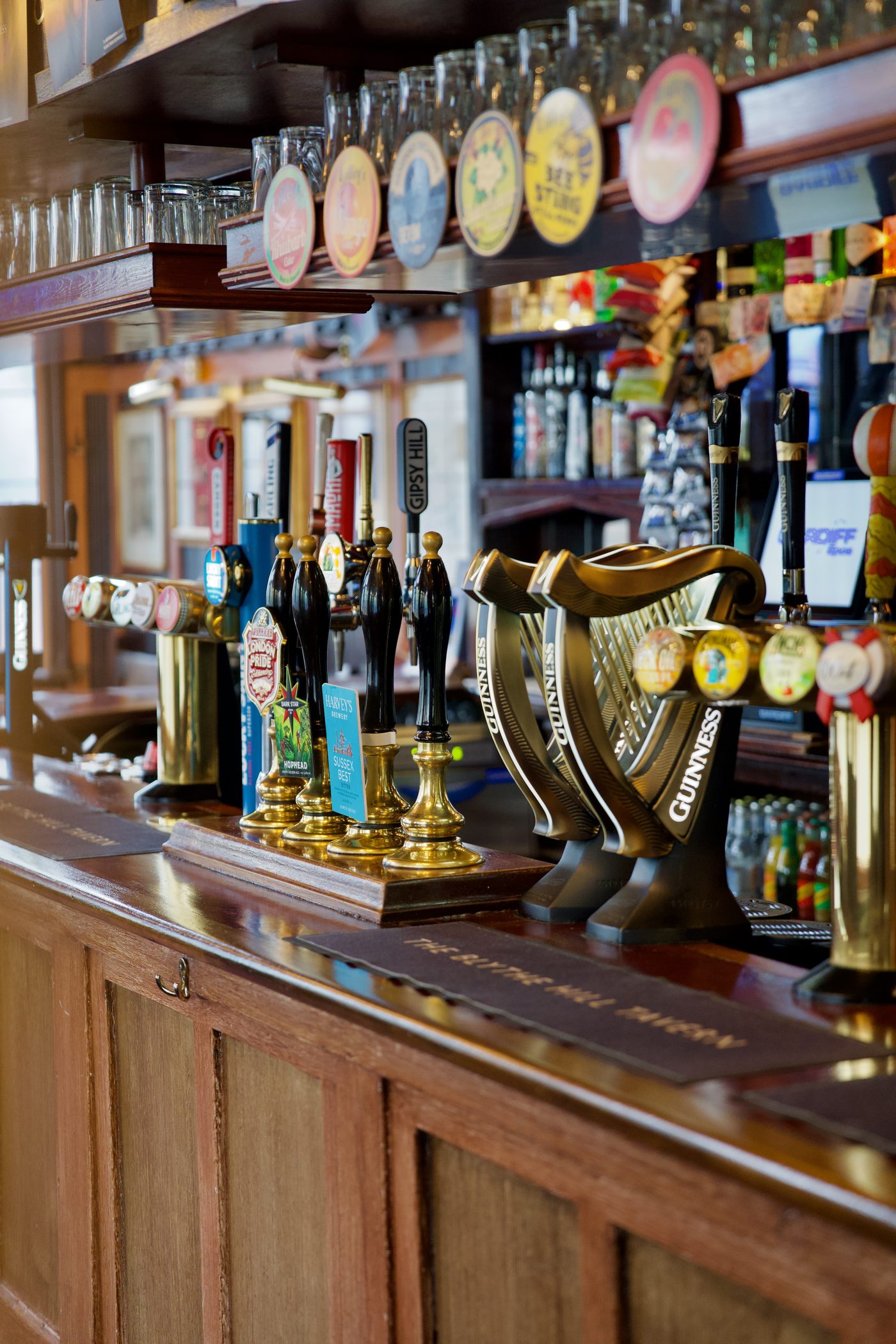 Brass handpulls along the bar — London Pride, Dark Star Hophead and Harvey's Sussex Best — with the Guinness founts alongside