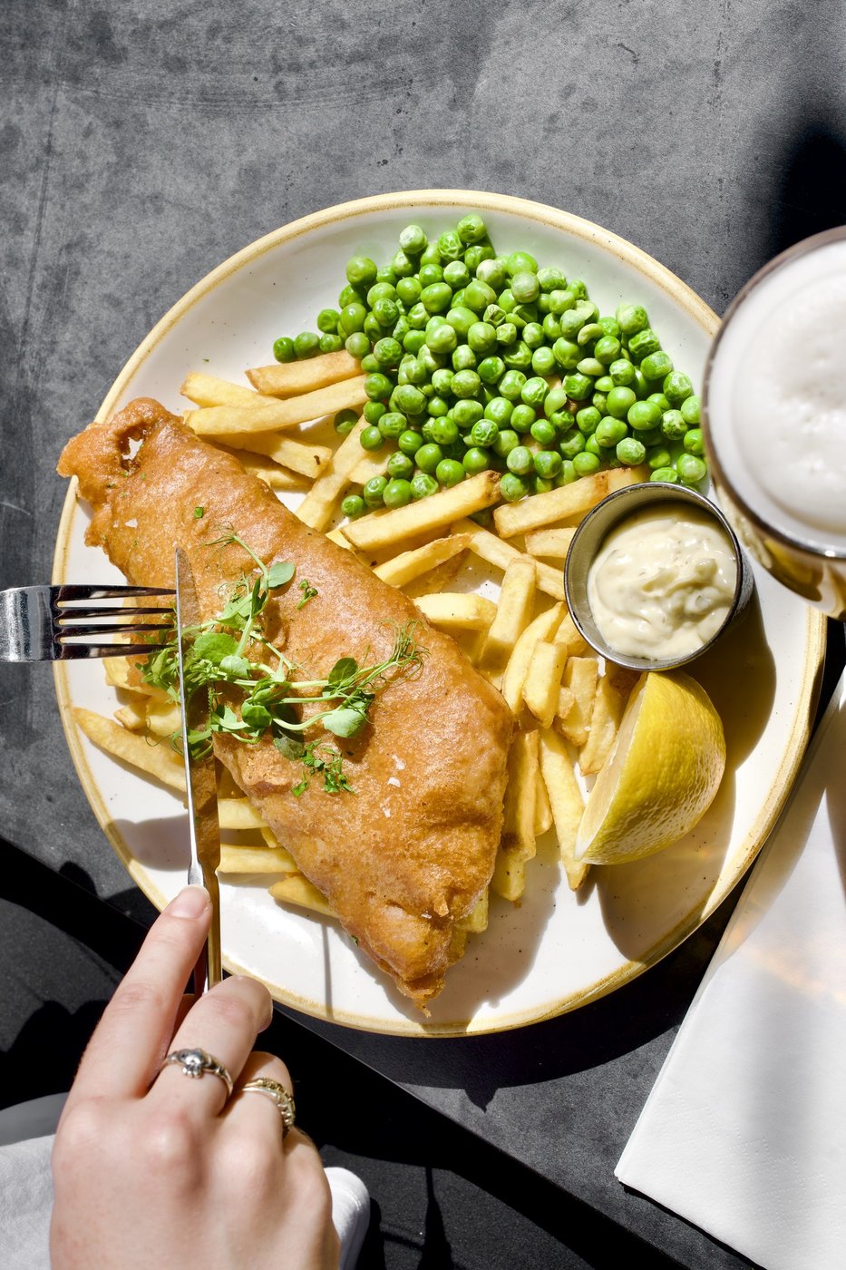 Battered fish with chips, peas and tartare sauce