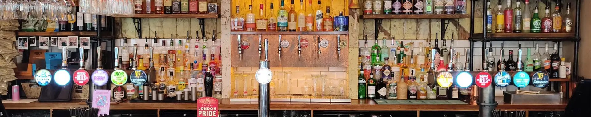 Spirits shelves and beer taps along the back bar