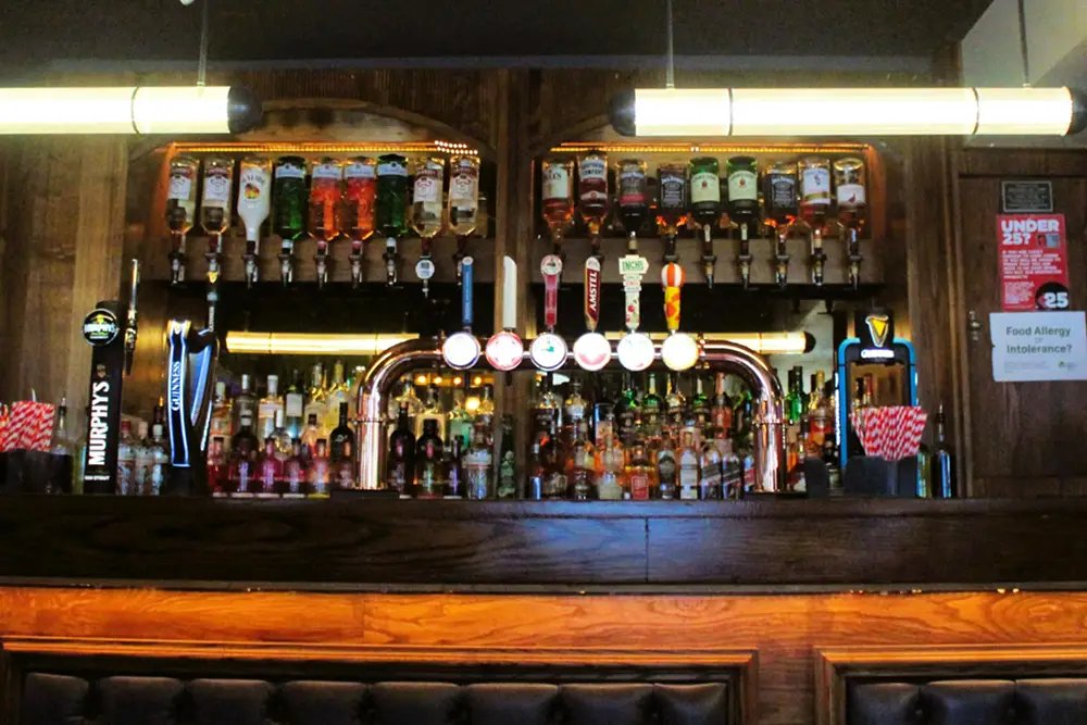 The bar at The Foundry: spirits and gins on the back shelf, taps in front