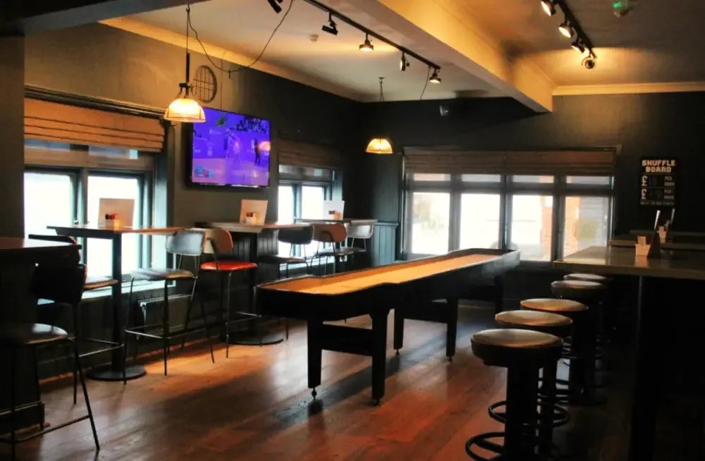 A shuffleboard table in the games area